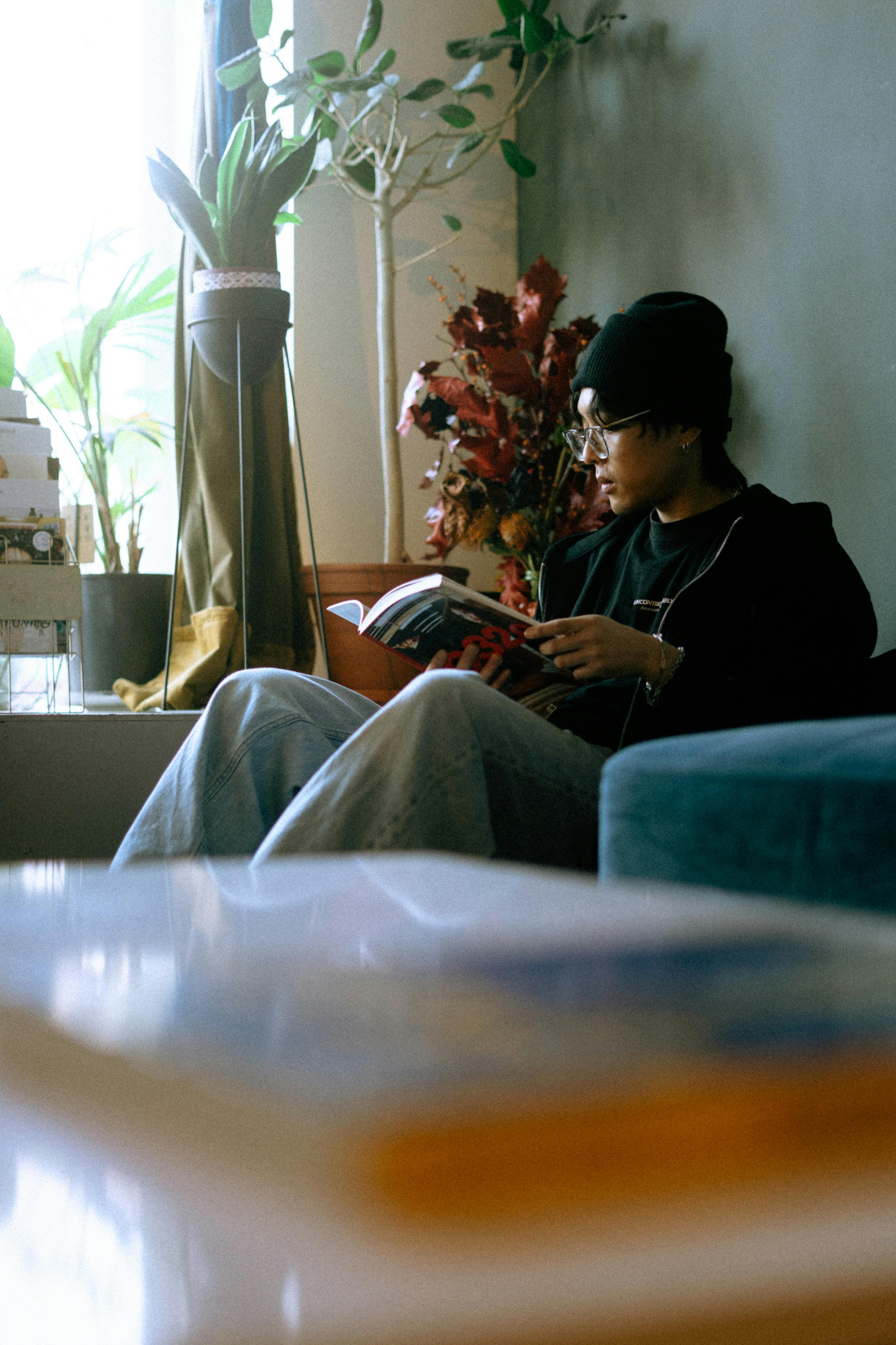 A person sitting by a bright window in a calm indoor space.
